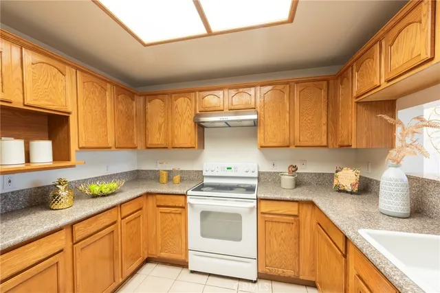 a kitchen with granite countertop a sink stainless steel appliances and cabinets