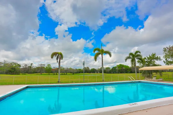 a front view of a building with a garden