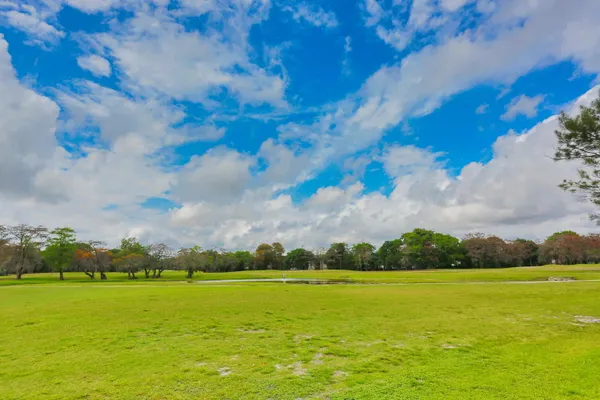 a front view of multi story residential apartment building with yard
