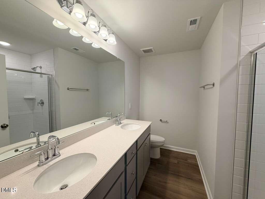 5024 Reader Way Durham, NC 27703 - Photo 18 of 26 a bathroom with a sink double vanity and a mirror