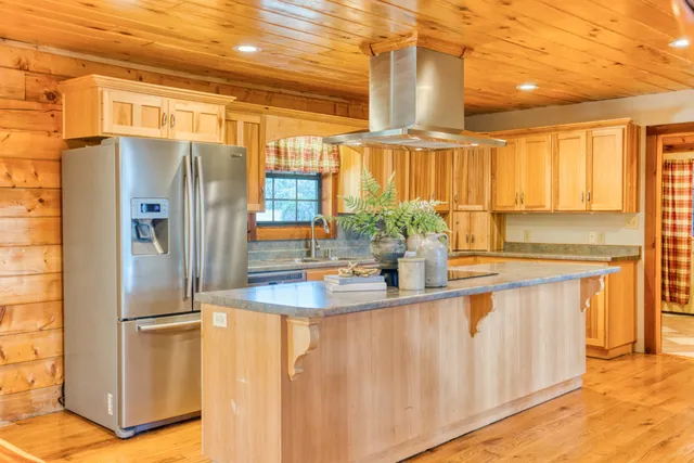 a kitchen with stainless steel appliances granite countertop a sink and a counter space