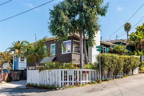 a view of a house with wooden fence