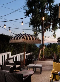 a view of a roof deck with table and chairs and potted plants