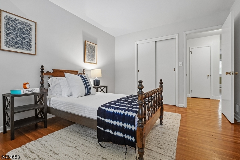 106 Division Avenue Summit, NJ 07901 - Photo 23 of 38 a bedroom with a bed and wooden floor
