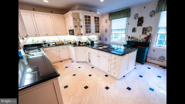 a large white kitchen with a stove a sink and dishwasher