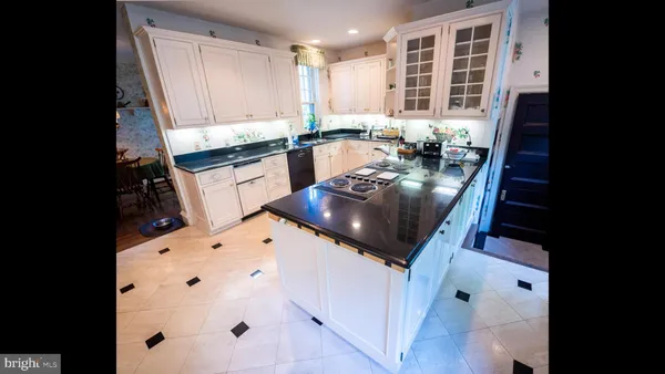a kitchen with granite countertop a sink stove and cabinets