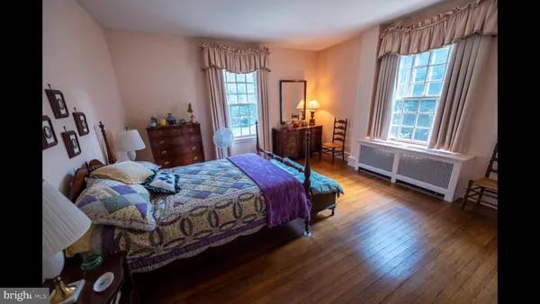 a bed room with a bed and a large window