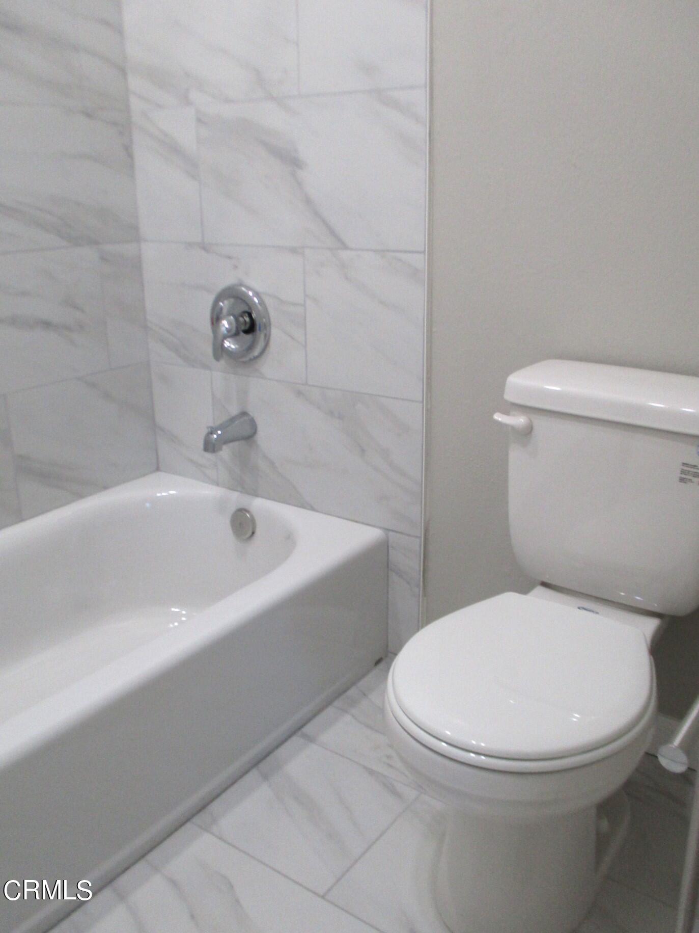 375 West Walnut Street Pasadena, CA 91103 - Photo 23 of 42 a white toilet and tub sitting next to a bathroom sink