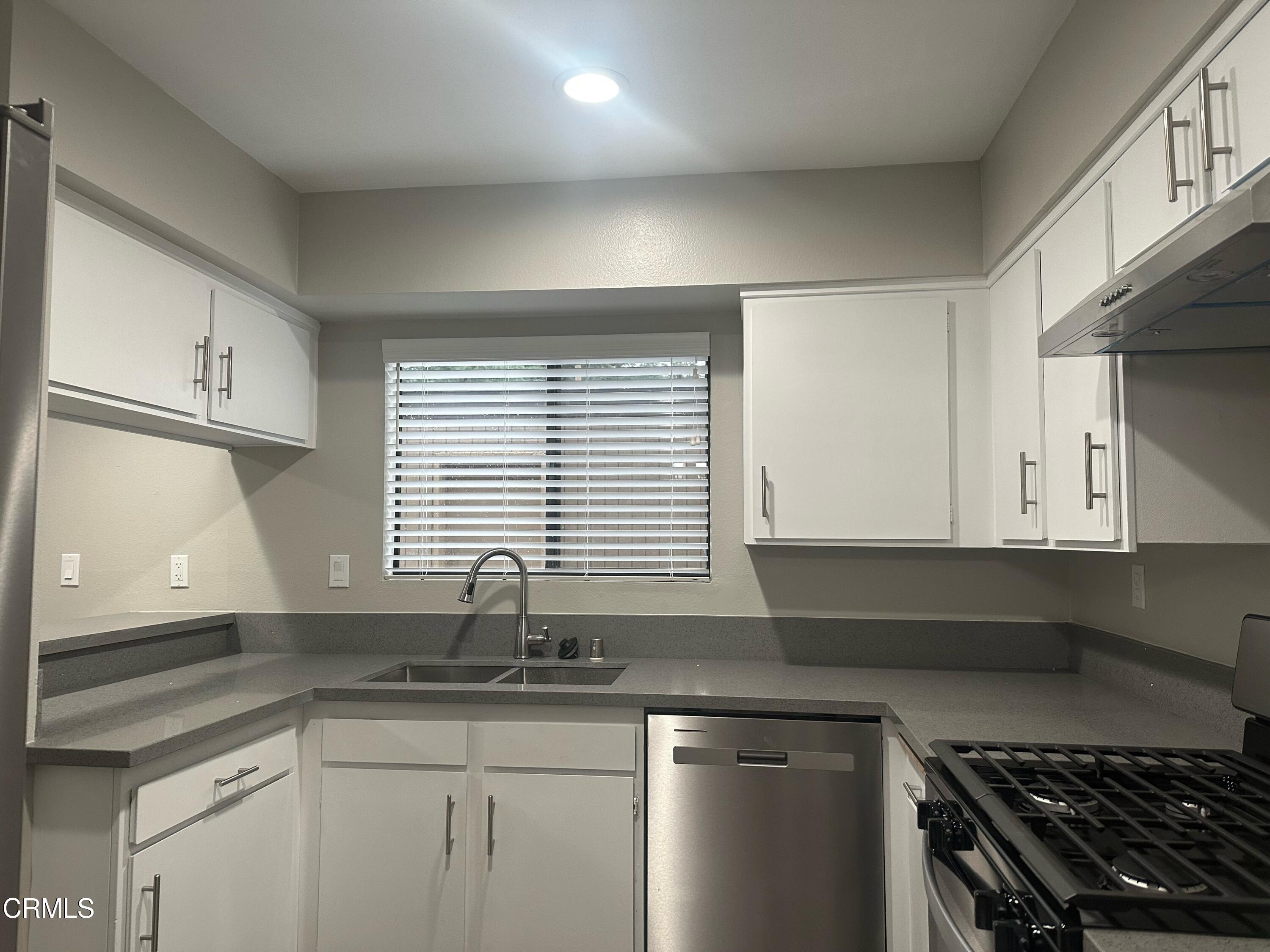 375 West Walnut Street Pasadena, CA 91103 - Photo 8 of 42 a kitchen with granite countertop a sink a stove and cabinets