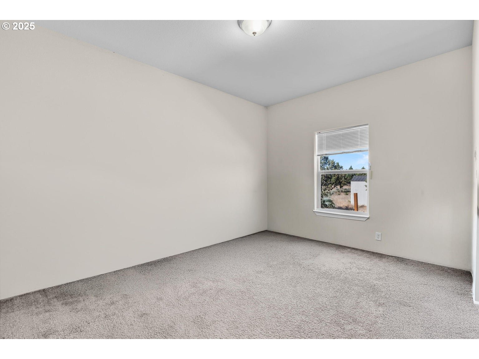 16277 Southeast Cahvilla Road Prineville, OR 97754 - Photo 7 of 22 a view of an empty room with a window