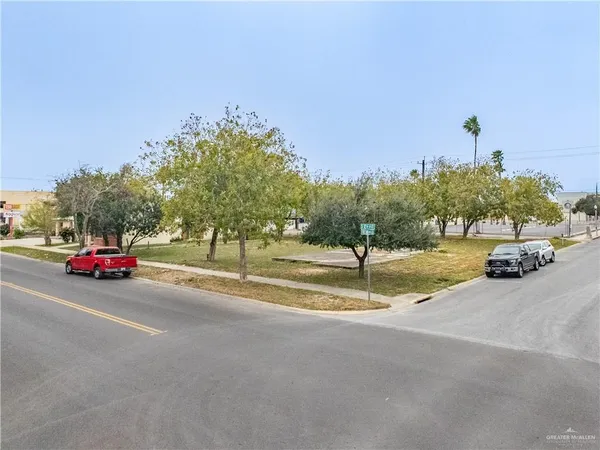 a view of a street with a building and car parked on the road