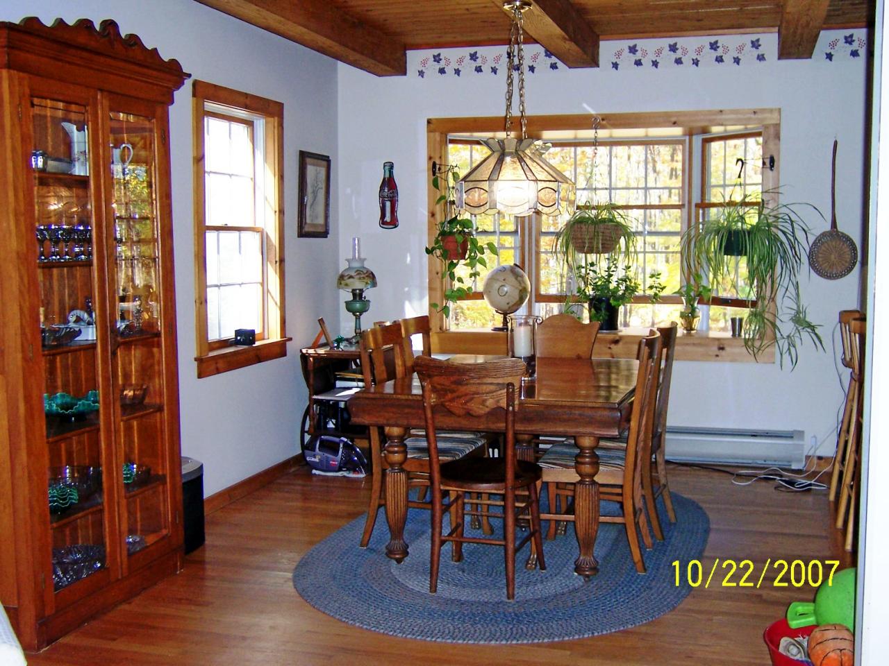 1304 George Carter Road Becket, MA 01223 - Photo 7 of 12 a view of a dining room with furniture window and wooden floor