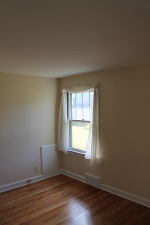 926 Plumtree Road Springfield, MA 01119 - Photo 13 of 21 an empty room with wooden floor and windows