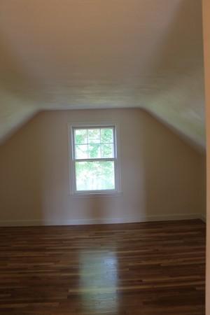 926 Plumtree Road Springfield, MA 01119 - Photo 16 of 21 a view of an empty room with wooden floor and a window