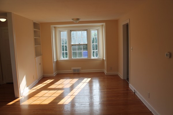 926 Plumtree Road Springfield, MA 01119 - Photo 8 of 21 a view of empty room with wooden floor and fan