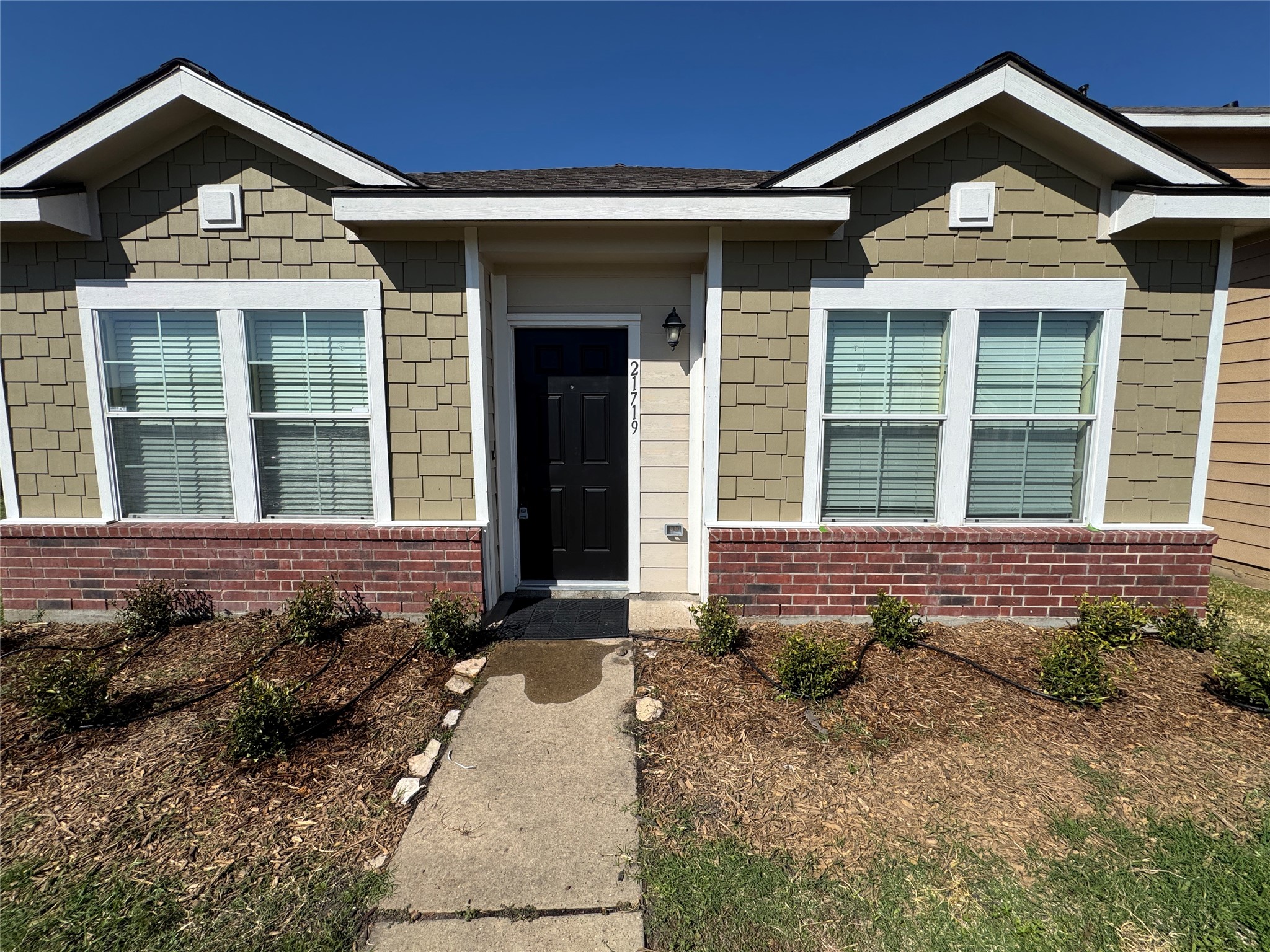 a front view of a house with garden