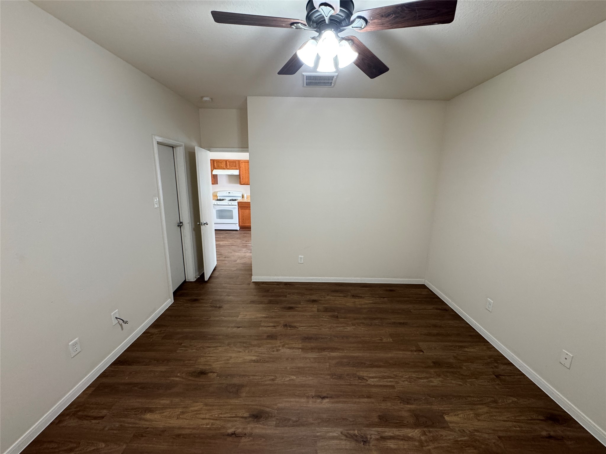 21719 Mossy Field Lane Spring, TX 77388 - Photo 29 of 44 a view of an empty room with wooden floor and a ceiling fan