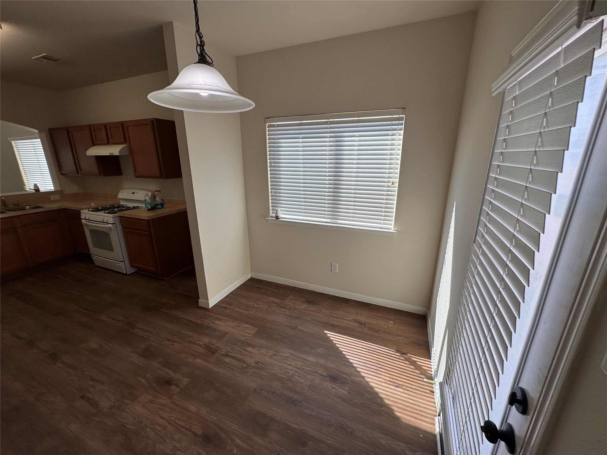 21719 Mossy Field Lane Spring, TX 77388 - Photo 6 of 44 a view of a kitchen with a sink dishwasher wooden floor and a window