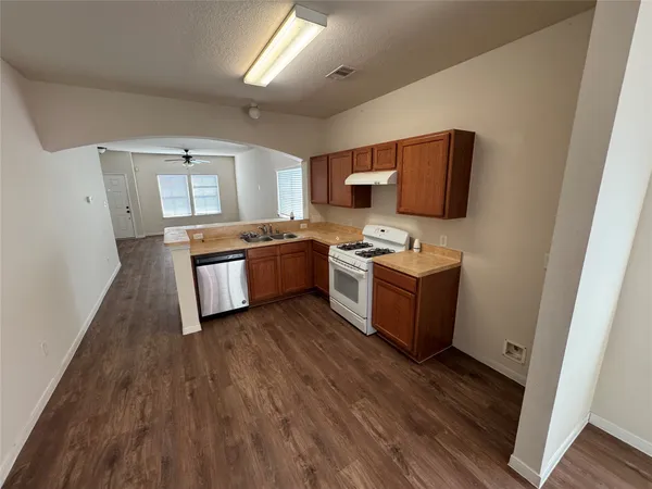 a kitchen with stainless steel appliances a stove a sink and a refrigerator