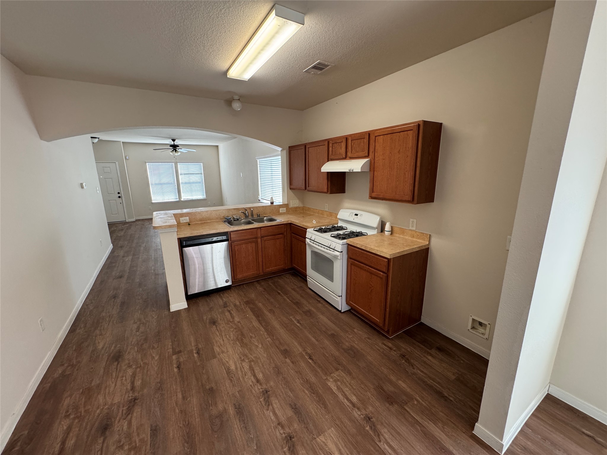 21719 Mossy Field Lane Spring, TX 77388 - Photo 8 of 44 a kitchen with stainless steel appliances a stove a sink and a refrigerator