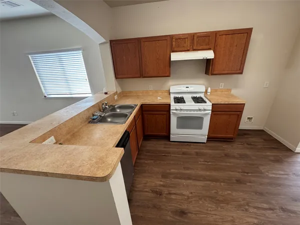 a kitchen with granite countertop a stove and a sink