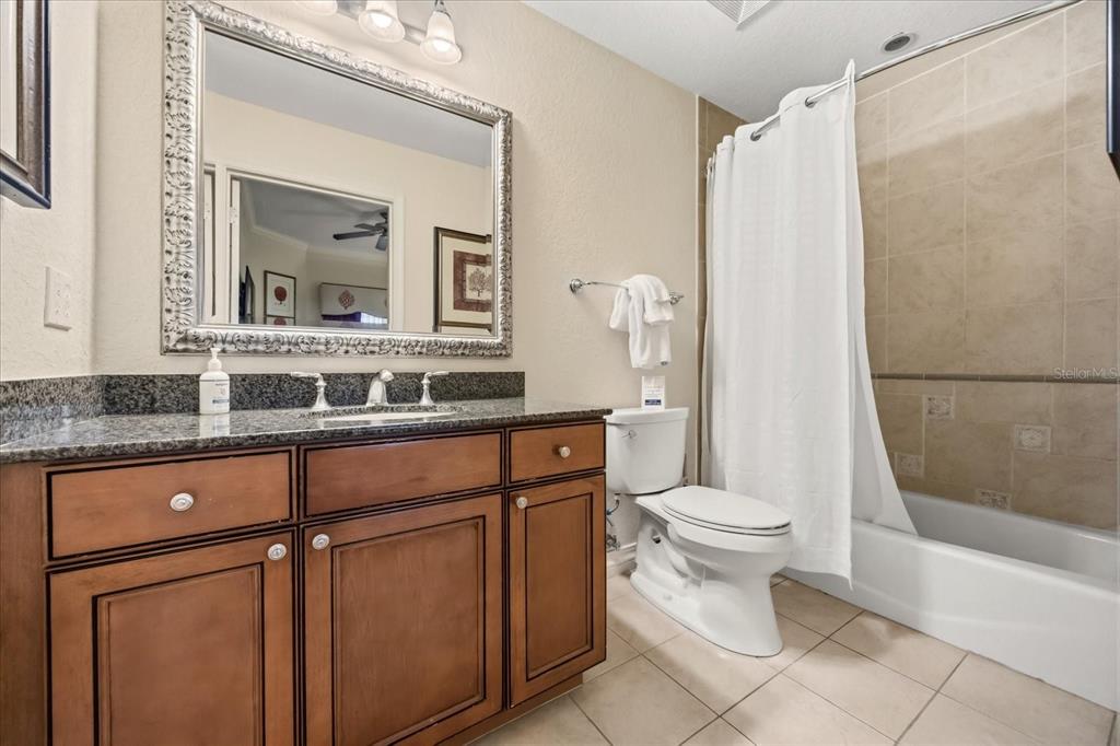 1114 Sunset View Circle, Unit 402 Reunion, FL 34747 - Photo 11 of 32 a bathroom with a sink a toilet and a mirror
