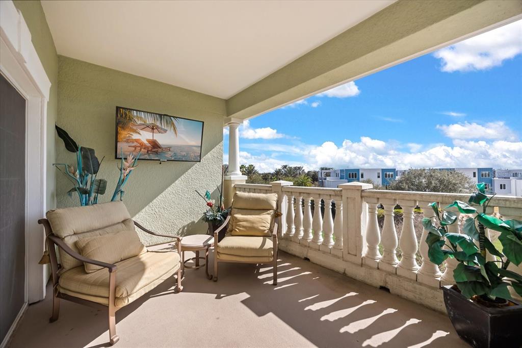 1114 Sunset View Circle, Unit 402 Reunion, FL 34747 - Photo 14 of 32 a balcony with couple of chairs and wooden floor