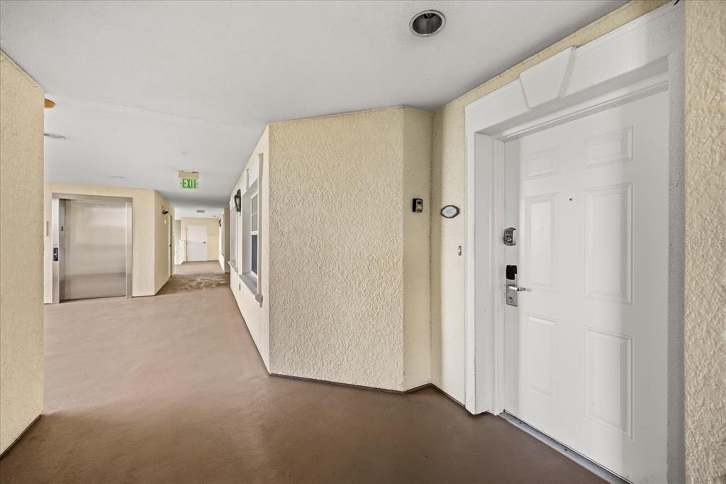 1114 Sunset View Circle, Unit 402 Reunion, FL 34747 - Photo 15 of 32 a view of a hallway with closet area