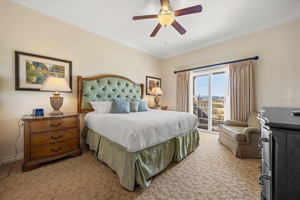 1114 Sunset View Circle, Unit 402 Reunion, FL 34747 - Photo 7 of 32 a bedroom with a bed and a chandelier