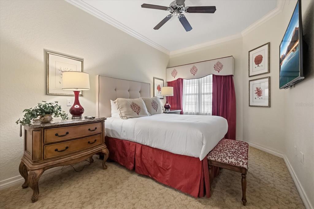 1114 Sunset View Circle, Unit 402 Reunion, FL 34747 - Photo 10 of 32 a bedroom with a bed dresser and a window