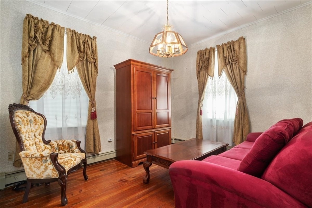 128 Diman Street Fall River, MA 02721 - Photo 13 of 42 a living room with furniture fireplace and dining table