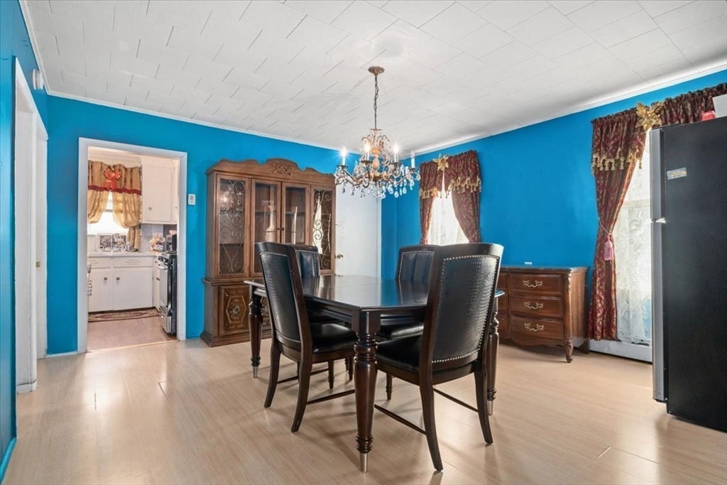 128 Diman Street Fall River, MA 02721 - Photo 17 of 42 a dining room with furniture a chandelier and wooden floor