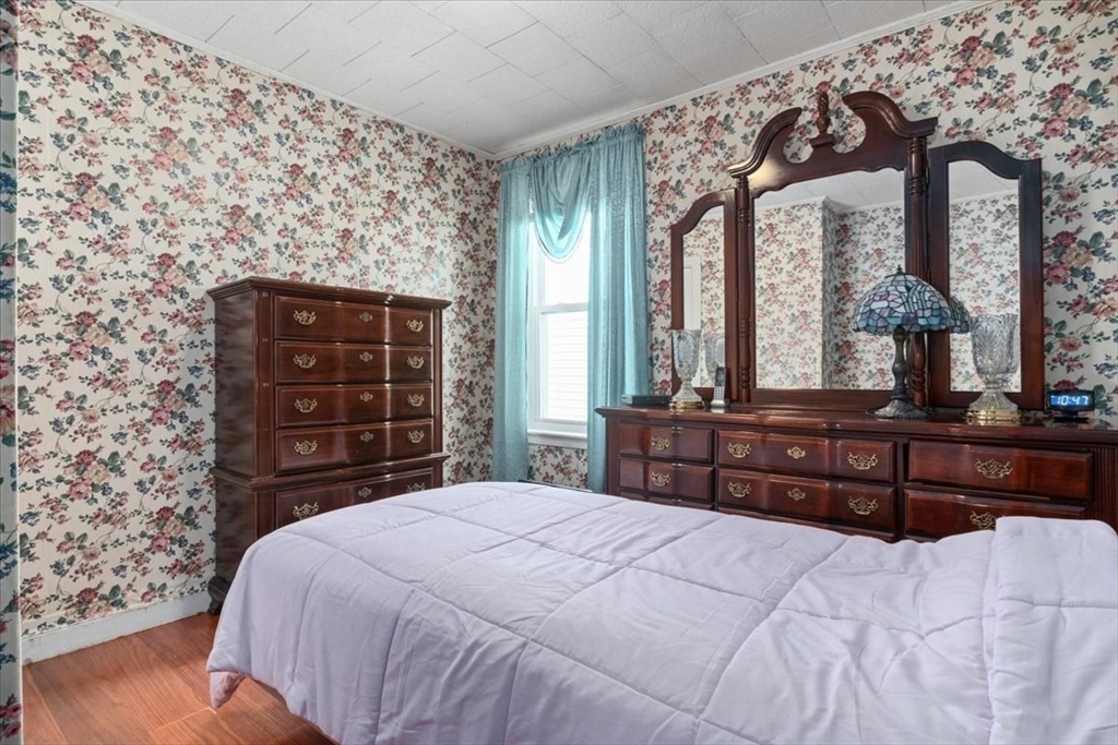 128 Diman Street Fall River, MA 02721 - Photo 21 of 42 a bedroom with a bed large window and dresser