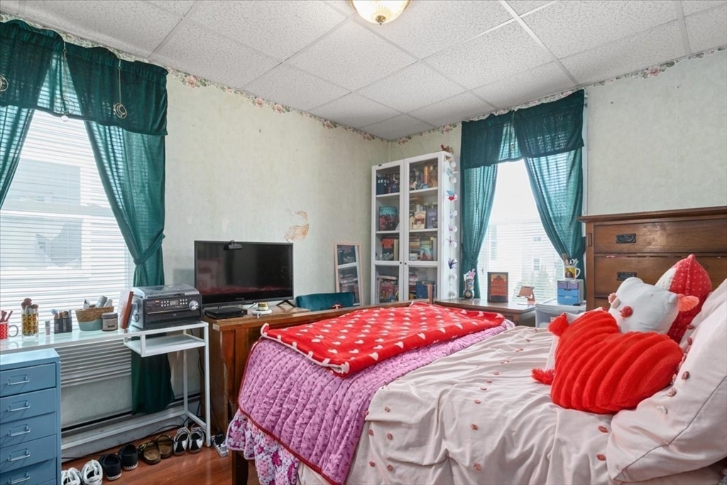 128 Diman Street Fall River, MA 02721 - Photo 23 of 42 a bedroom with a bed and a flat screen tv