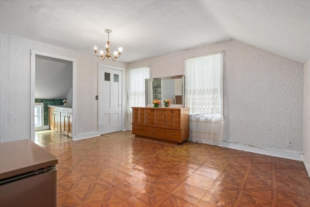 128 Diman Street Fall River, MA 02721 - Photo 26 of 42 a living room with furniture and a chandelier