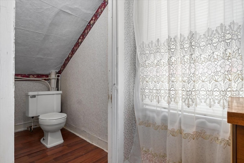 128 Diman Street Fall River, MA 02721 - Photo 27 of 42 a bathroom with a toilet and a shower curtain