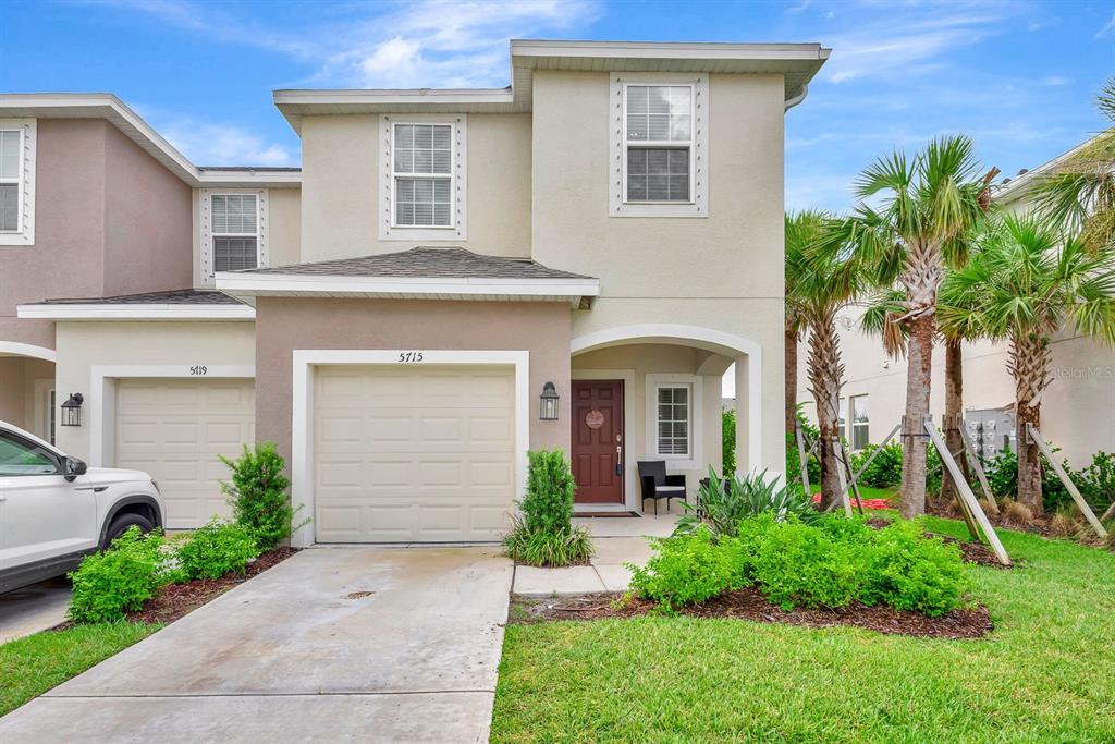 5715 Archipelago Street Nokomis, FL 34275 - Photo 2 of 52 a front view of a house with a yard and potted plants