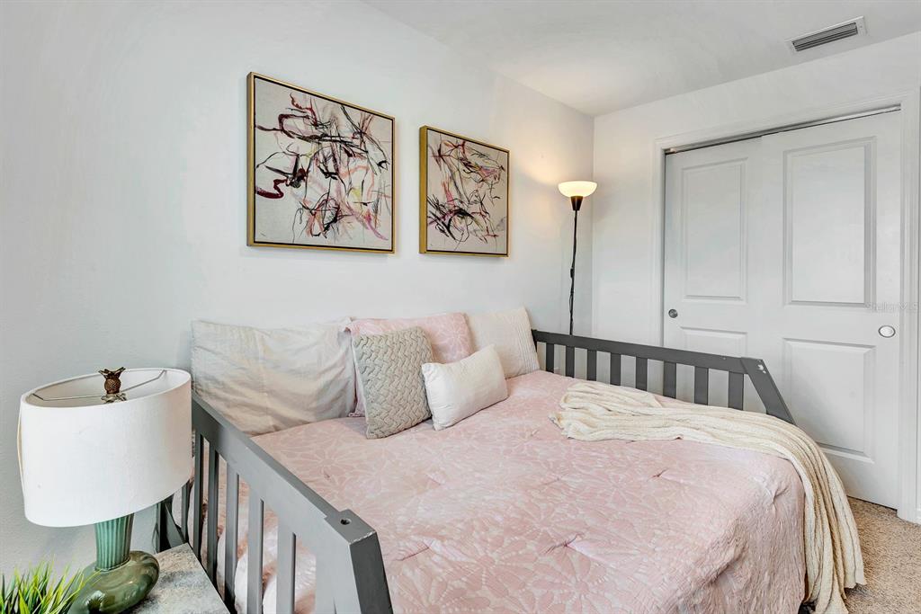 5715 Archipelago Street Nokomis, FL 34275 - Photo 34 of 52 a bedroom with a bed and a lamp on dresser