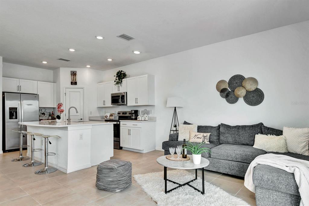 5715 Archipelago Street Nokomis, FL 34275 - Photo 10 of 52 a living room with furniture and kitchen view