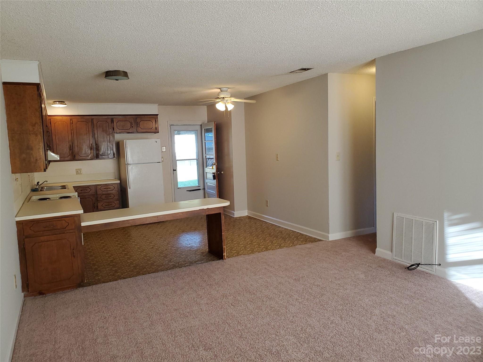 6100 Pleasant Grove Road Charlotte, NC 28216 - Photo 4 of 14 a living room with furniture and a table