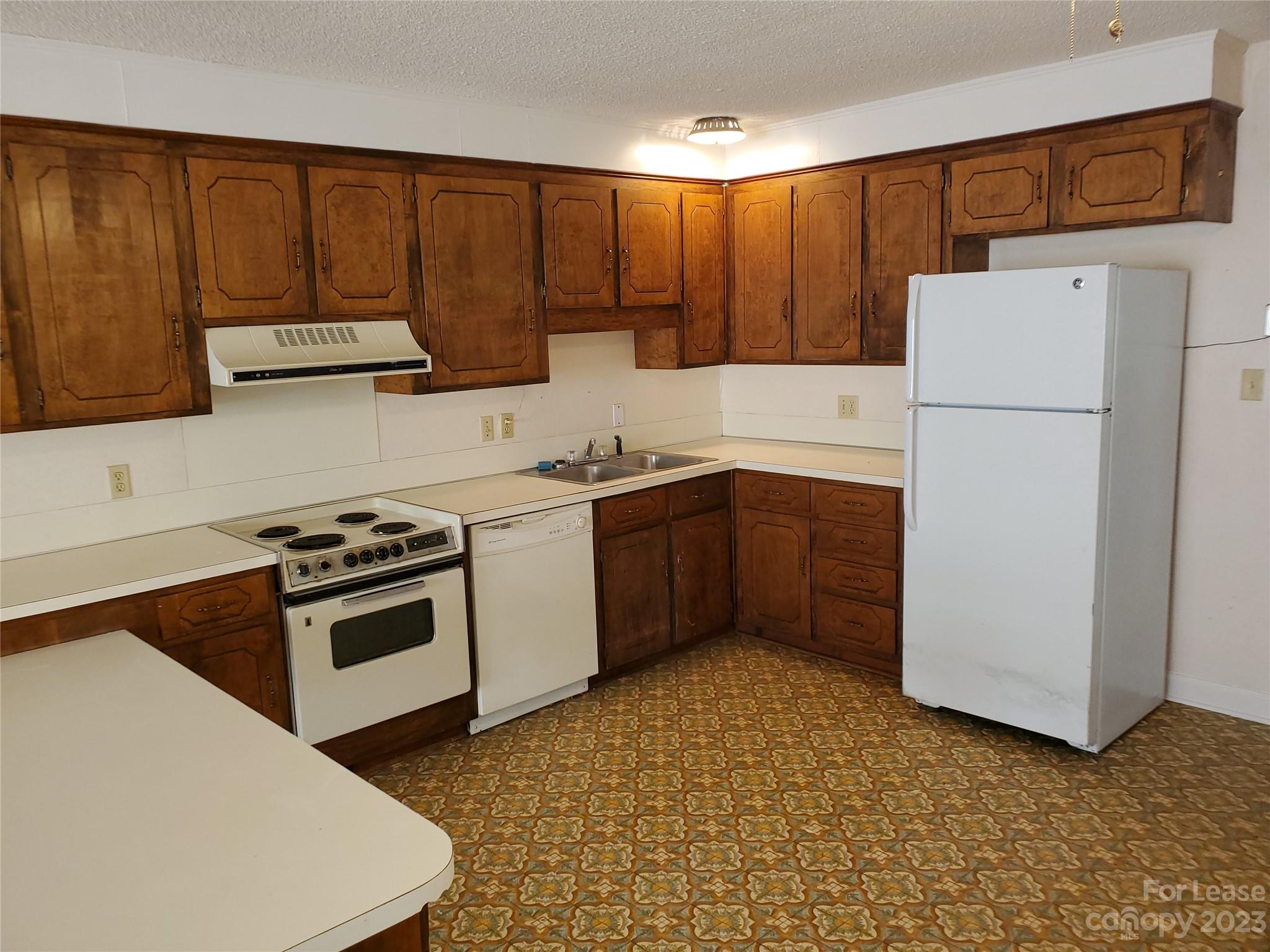 6100 Pleasant Grove Road Charlotte, NC 28216 - Photo 6 of 14 a kitchen with a cabinets and white appliances