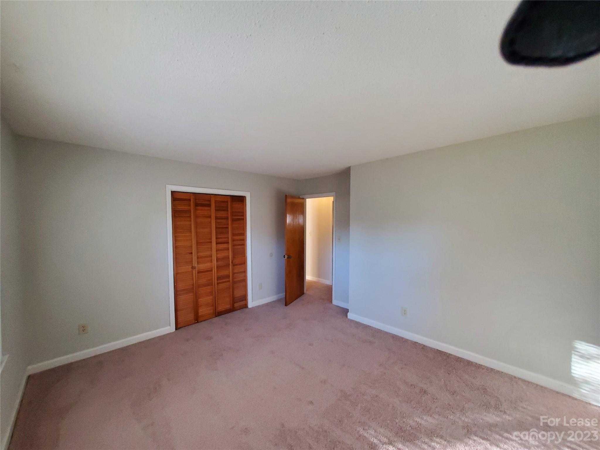 6100 Pleasant Grove Road Charlotte, NC 28216 - Photo 8 of 14 an empty room with windows