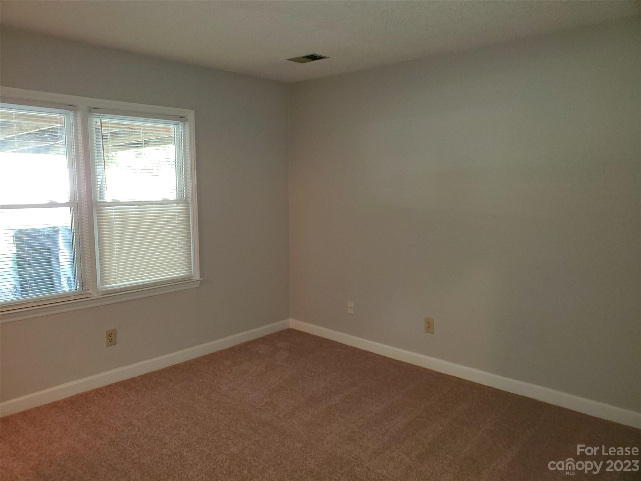 6100 Pleasant Grove Road Charlotte, NC 28216 - Photo 9 of 14 an empty room with a window