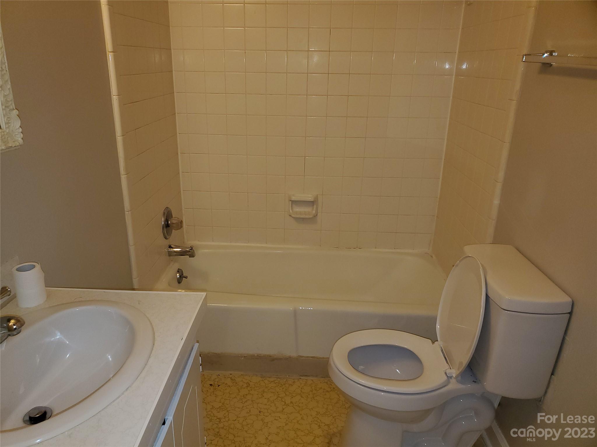 6100 Pleasant Grove Road Charlotte, NC 28216 - Photo 10 of 14 a bathroom with a sink and a toilet