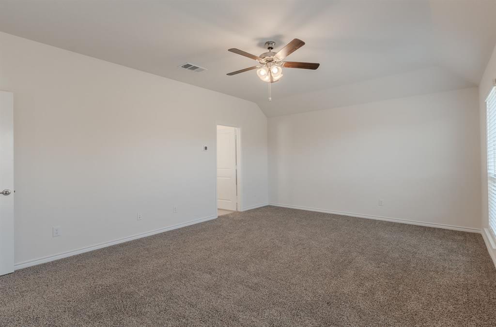 2902 Trusting Way Aubrey, TX 76227 - Photo 27 of 38 Spacious room featuring neutral carpeting, white painted walls, a vaulted ceiling, a ceiling fan with integrated lighting, and a window with horizontal blinds