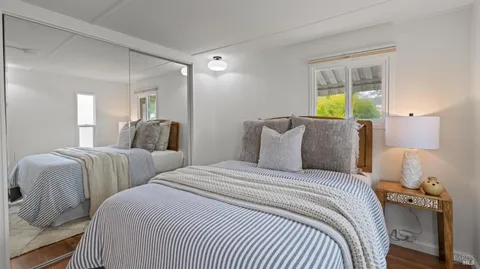 a bedroom with two beds and a window
