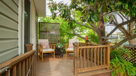 a view of balcony with wooden floor and outdoor seating