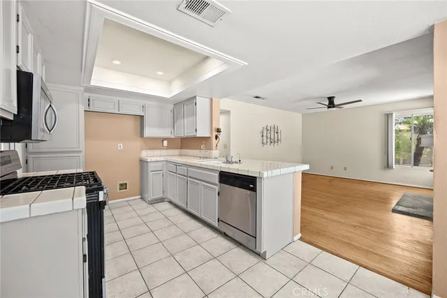 a kitchen with white cabinets and white appliances