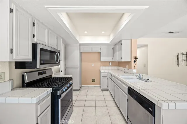 a kitchen with a sink stove and microwave