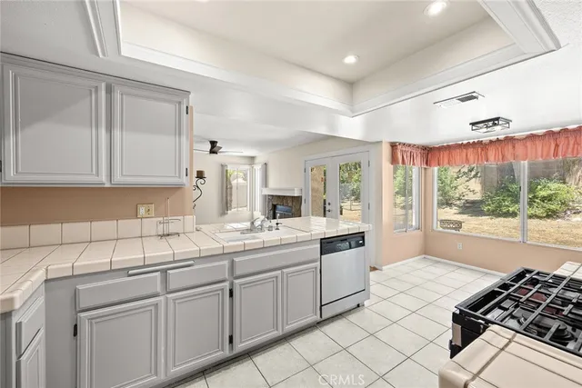 a kitchen with a sink appliances and cabinets